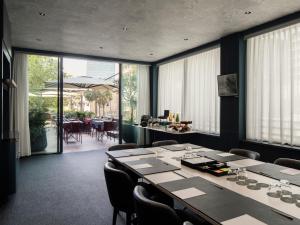 a conference room with a long table and chairs at Hyatt Centric Milan Centrale in Milan