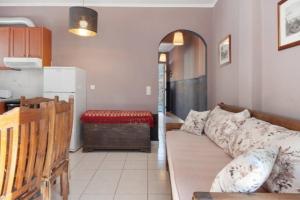 a living room with a couch and a kitchen at Panana Irida in Mérikhas