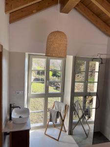 a bathroom with two chairs and a large window at Casa Rural A Costa - Villa Rustica Asturias - Boal in Boal +13 photos