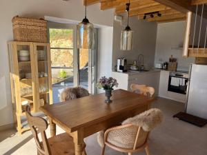 a kitchen with a wooden dining table and chairs at Casa Rural A Costa - Villa Rustica Asturias - Boal in Boal