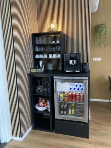 a small refrigerator with its door open in a room at B&B De Hofnar Roermond in Roermond