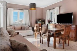 a living room with a table and a tv at Panana Irida in Mérikhas