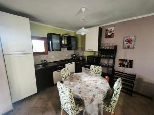 a kitchen with a table and chairs in a room at Good Time house in Aprilia Marittima