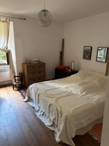 a bedroom with a bed and a dresser and a window at Maison de village in Ortiporio