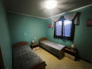 a bedroom with two beds and a window at Good Time house in Aprilia Marittima