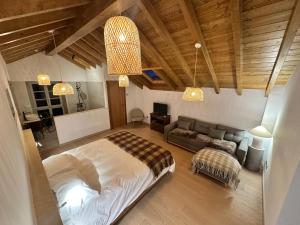 a bedroom with a bed and a couch at Casa Rural A Costa - Villa Rustica Asturias - Boal in Boal
