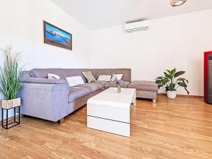a living room with a couch and a table at Apartment Paz by Interhome in Donji Proložac