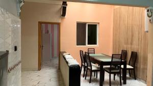 a dining room with a table and chairs at AMAZIGH BIG Family APARTMENT in Meknès +14 photos