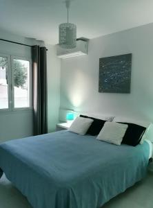 a bedroom with a large bed and a window at Villa Brehat avec piscine privée in Cala en Porter +11 photos