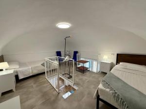 a bedroom with two beds and a table and a bed at BUDELLO Apartament in Alassio