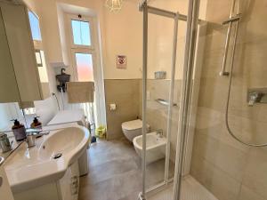 a bathroom with a shower and a sink and a toilet at BUDELLO Apartament in Alassio +18 photos