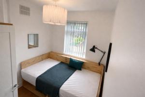 a small bedroom with a bed and a window at Contractor Base Newport 3 Bed Van Parking Sleeps 5 in Newport
