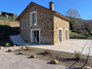 a brick house with a driveway in front of it at Casa Rural A Costa - Villa Rustica Asturias - Boal in Boal