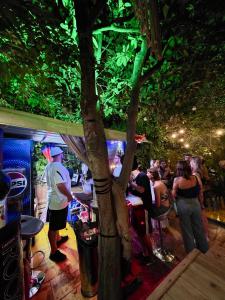 a group of people sitting at tables in a bar at Blue Door Hostel in Tirana