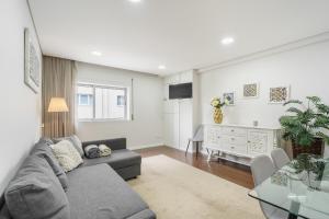 a living room with a couch and a table at Libertà Lodge Apartment - Minho's Guest in Braga