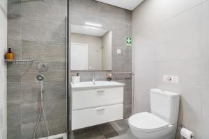 a bathroom with a toilet and a sink and a shower at Libertà Lodge Apartment - Minho's Guest in Braga +16 photos