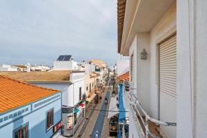 a view of a street in a town with buildings at Apartamento 3 Nações in Alvor
