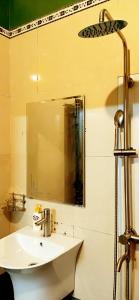 a bathroom with a sink and a mirror at Cozy Bunk Sa Pa in Sapa
