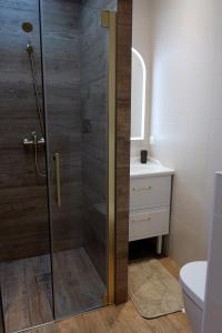 a shower with a glass door in a bathroom at VANILLA Lodge in Lacanau-Océan +11 photos