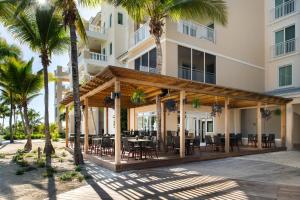 a gazebo in front of a building with palm trees at Blue Haven Resort- All Inclusive in Providenciales