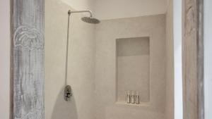 a shower with a shower head in a bathroom at Zahari Oceanfront in Msambweni