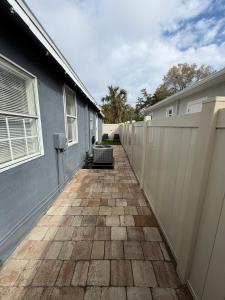 a walkway outside of a house with a fence at Suite Safari in Tampa