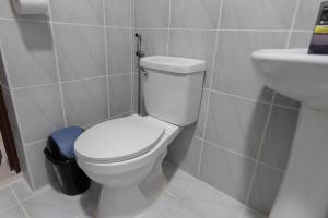 a bathroom with a white toilet and a sink at Affordable Condo in Cebu with Great Views in Suba