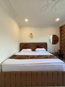 a bedroom with a large bed in a room at Hotel Crescent in Srinagar