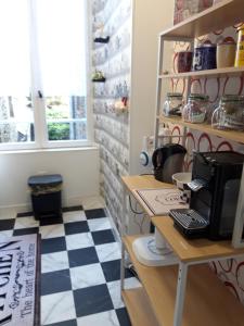 a kitchen with a black and white checkered floor at TINCHEBRAY Centre ville in Tinchebray