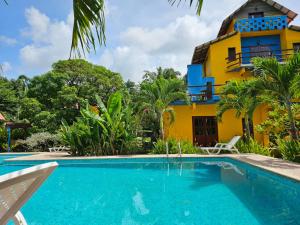 a house with a swimming pool in front of a house at Livingston Resort Hotel in Lívingston