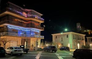 a parking lot with cars parked in front of a building at Bed & Breakfast Villa Emma in Paterno