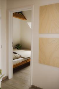 a bedroom with a bed and a door leading into a room at Apartman Barbara in Lipany