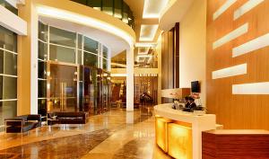 a lobby of a building with a reception desk at Hotel Santika Tasikmalaya in Tasikmalaya