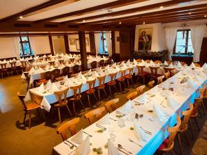 a large banquet hall with white tables and chairs at Gasthaus Adler Weilheim, Waldshut in Weilheim