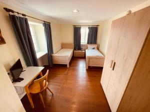 a small room with a bed and a desk at Gasthaus Adler Weilheim, Waldshut in Weilheim +17 photos