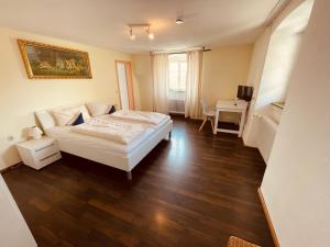 a small room with a bed and a desk at Gasthaus Adler Weilheim, Waldshut in Weilheim