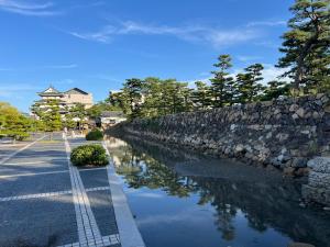 a stone wall next to a river with trees at 北浜703 3ベッドルーム貸切 高松港近く 最大6名 in Takamatsu