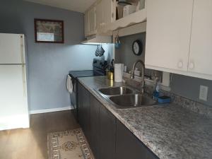 a kitchen with a sink and a counter top at GpL 4134 Cozy & Spacious 4BR Shared House in Fort Myers +29 photos