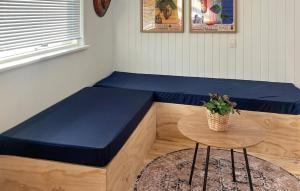 a blue bench in a room with a table at Amazing Home In Juelsminde With House Sea View in Juelsminde
