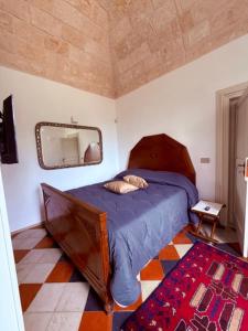 a bedroom with a bed and a mirror and a rug at VIlla Monte D'Alba in Trani