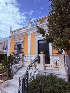 a yellow building with stairs in front of it at VIlla Monte D'Alba in Trani