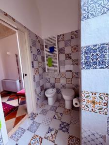 a bathroom with a toilet and a tiled floor at VIlla Monte D'Alba in Trani +17 photos