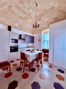 a kitchen with a table and chairs in a room at VIlla Monte D'Alba in Trani