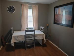 a room with a bed and a table and a window at GpL 4134 Cozy & Spacious 4BR Shared House in Fort Myers