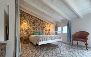 a bedroom with a bed and a stone wall at Convent Holiday Home in Petra +31 photos