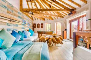 a living room with a bed and a pool table at The Beach Barn in Cardiff