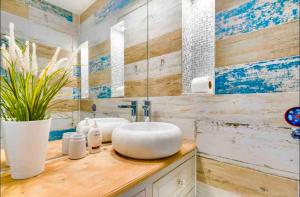 a bathroom with two sinks and a large mirror at The Beach Barn in Cardiff +30 photos