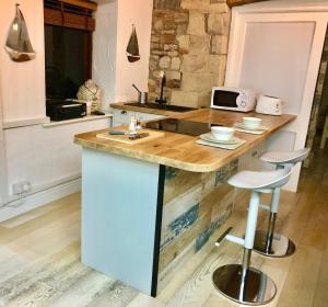 a kitchen with a counter with a sink at The Beach Barn in Cardiff