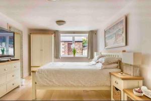 a bedroom with a large bed and a window at The Beach Barn in Cardiff