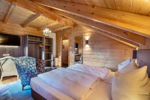 a bedroom with a large bed in a room with wooden walls at Haus Karin in Heiligenblut